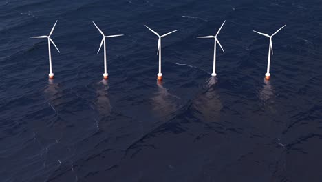 wind power plant in an ocean. five white tower turbine at front above the water.