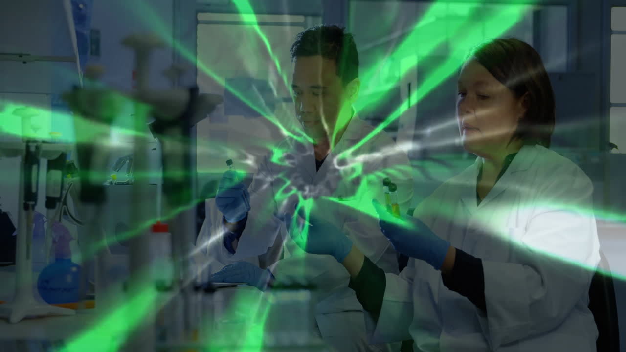 Scientists in lab coats working with green energy burst animation overlay