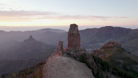 birds eye view around roque nublo with an orange glow from the sunset on the island of gran canaria.
