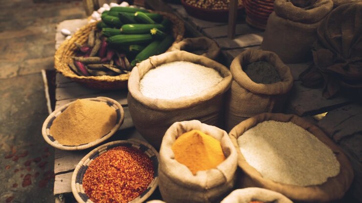 Colorful spices and fresh produce create a vibrant market scene