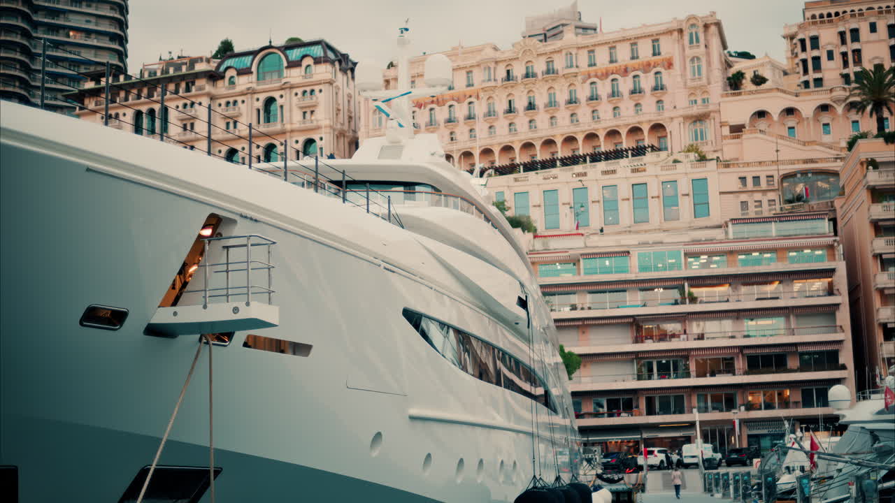 Close up view of boats docked in the Monaco Marina with buildings on the background. Vertical