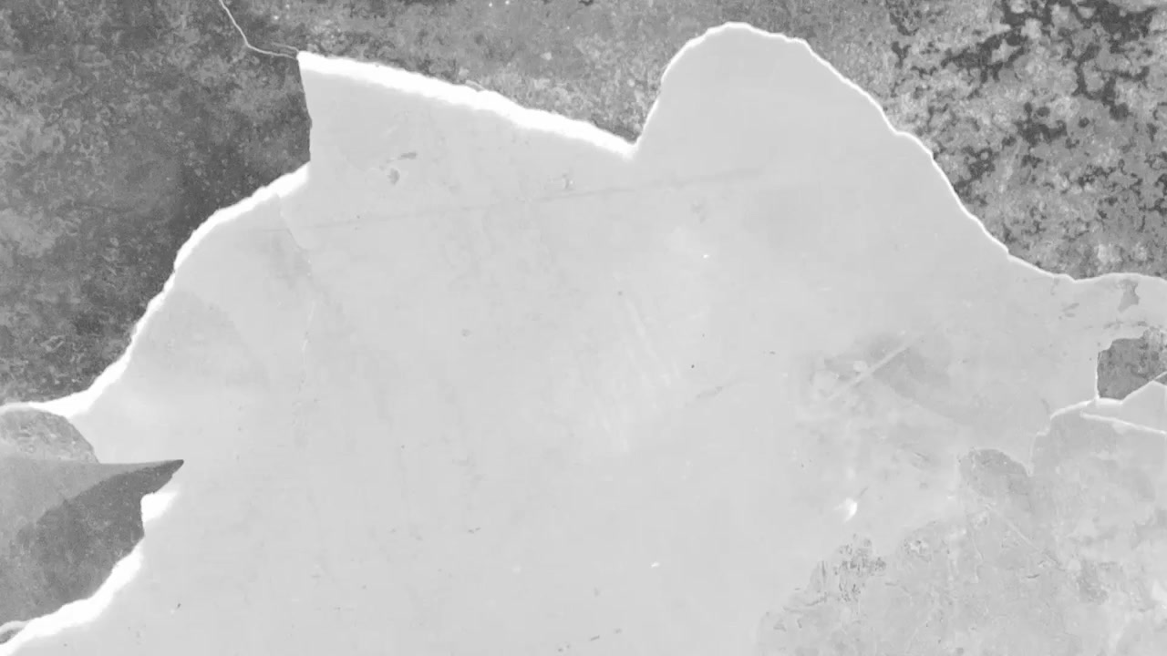 Close-up Abstract View of Ice Breaking and Cracking on a Dark Surface
