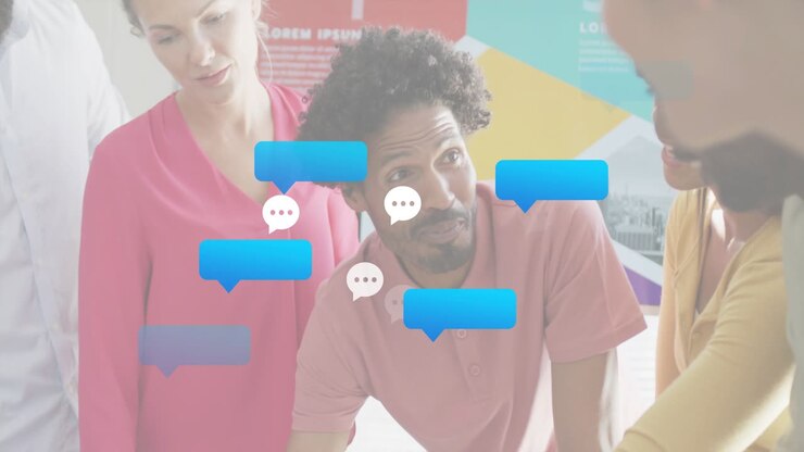 Man leaning forward, speaking in business meeting, chat bubbles clustering around him showing ideas