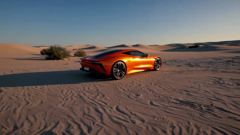 orange sports car in desert sand dunes