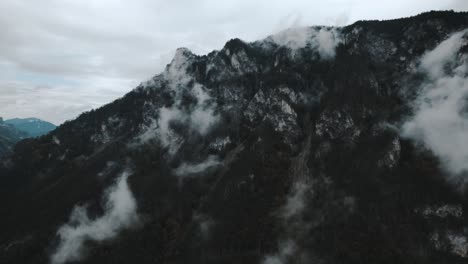 atmospheric and moody drone footage of mountainous landscapes in austria with wet and misty conditions