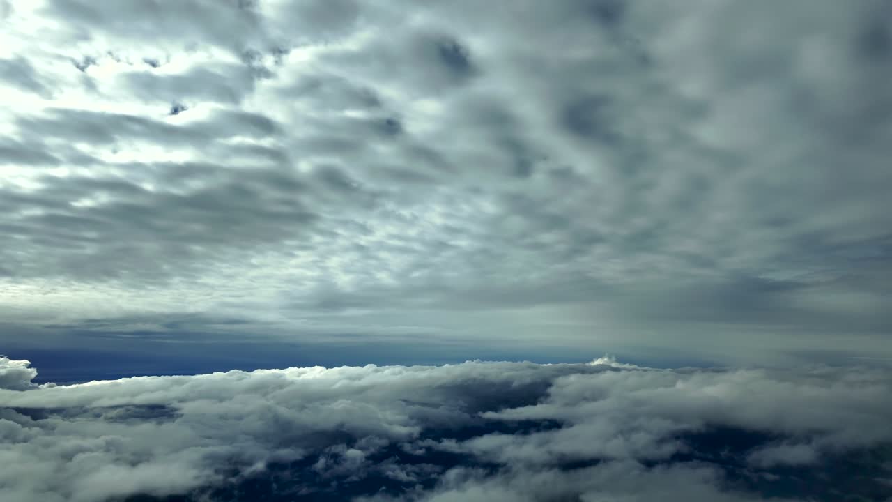 An immersive pilot’s eye in a real time flight at supersonic speed between layers of ethereal clouds in a multilayered sky