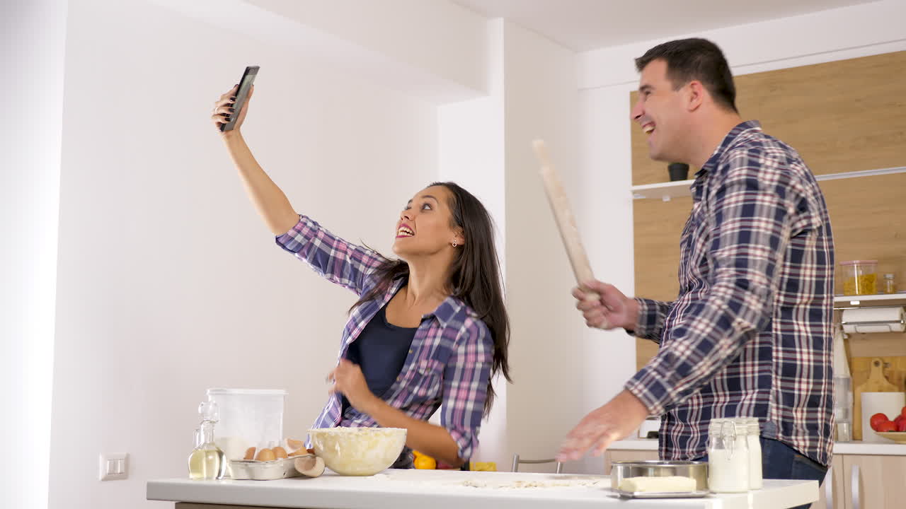 Couple Taking Selfie While Baking in Kitchen
