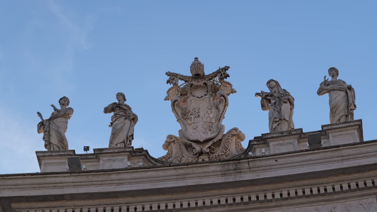 Papal emblem flanked by five detailed saint statues on the colonnade of St. Peter’s Square, Vatican City, Rome, under soft daylight and blue sky, captured in high resolution