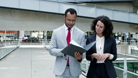 business people discussing papers