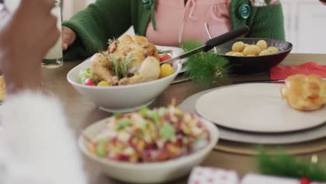 Close-up-of-african-american-family-having-christmas-dinner