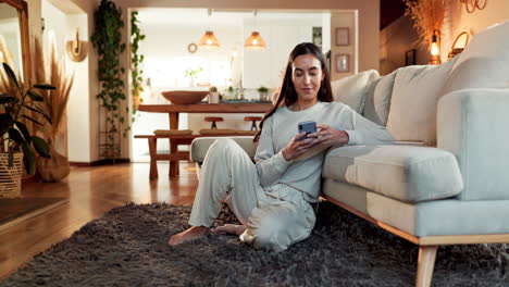 woman using smartphone in living room