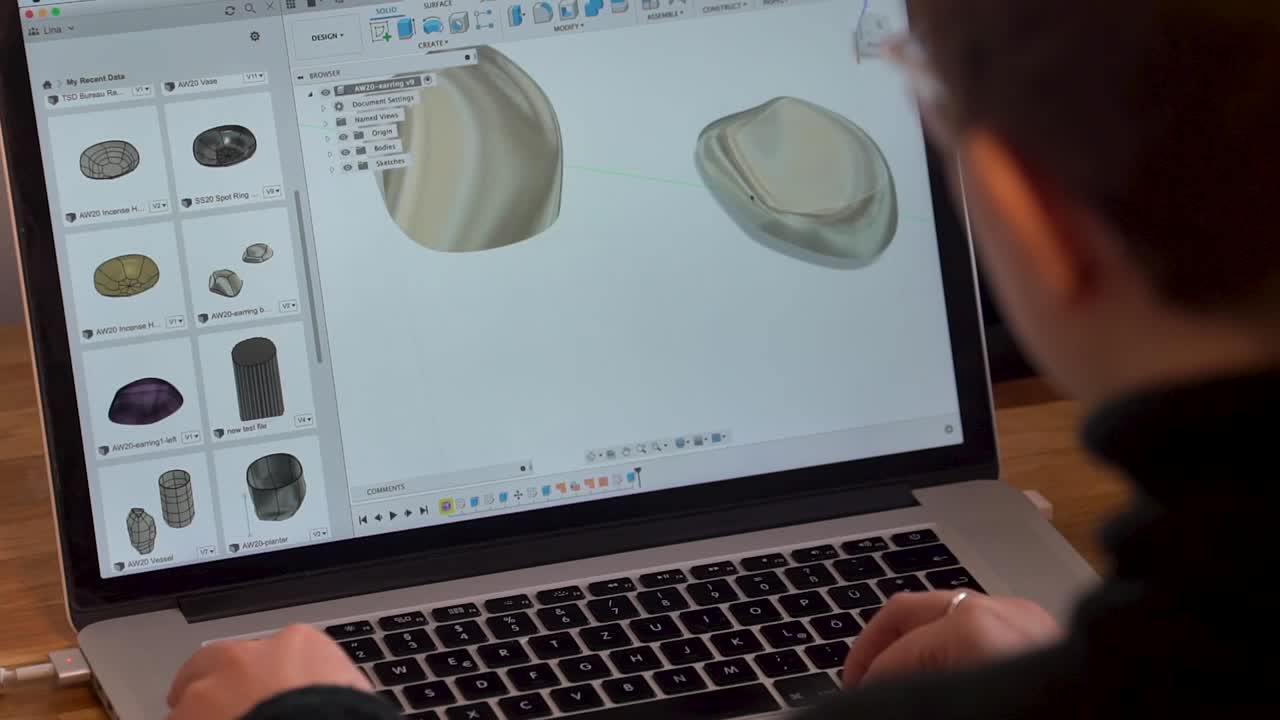 Product designer moving cad model on laptop
