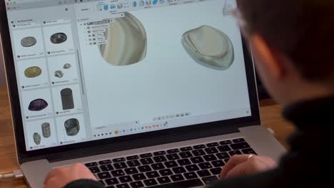 product designer moving cad model on laptop