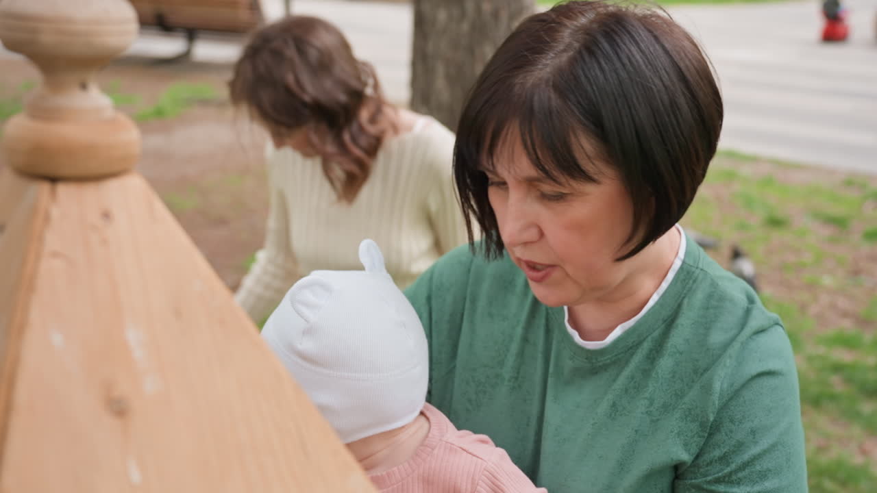 Family Plays Together, Parents And Grandma Supervise Children, Grandmother And Mother Inspect Playground Equipment Carefully, Family Members Collaboratively Check Wooden Play Structures In Park Today