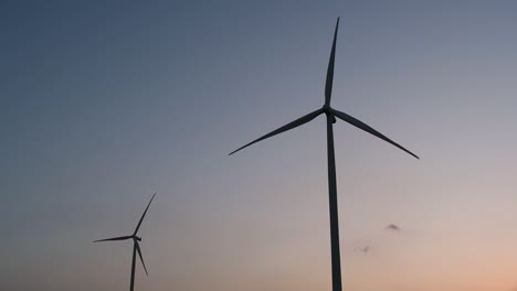 Wind-Turbines-Silhouette-against-the-Blue-sky-during-Sunset,-clean-alternative-energy-in-Thailand-and-mainland-Southeast-Asia