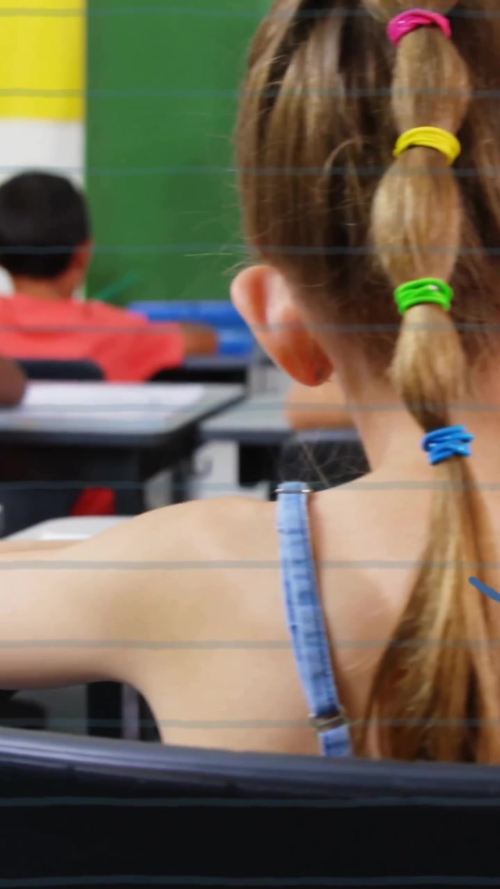 Animation of school items icons over diverse schoolchildren learning at school