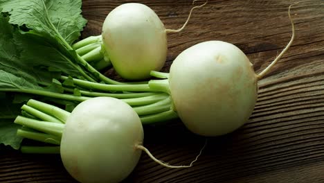 daikon radish.tasty fresh crude white round japanese radish with green stems and leaves