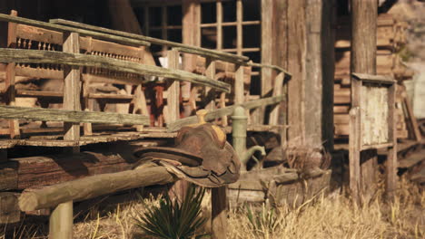 old western saddle on wooden fence