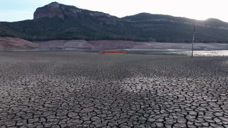 first-person view walking on dry shores of sau marsh with shipwreck of boat in background, catalonia, spain