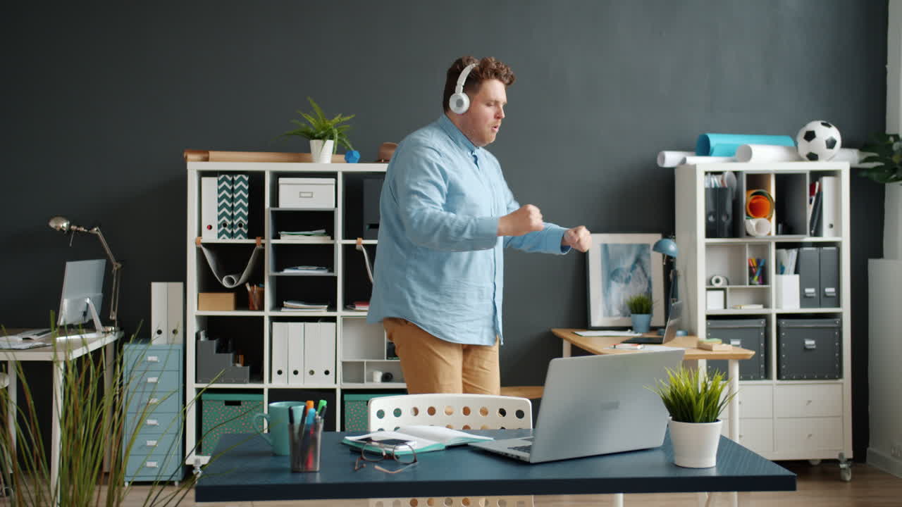 Man Dancing in Office While Listening to Music