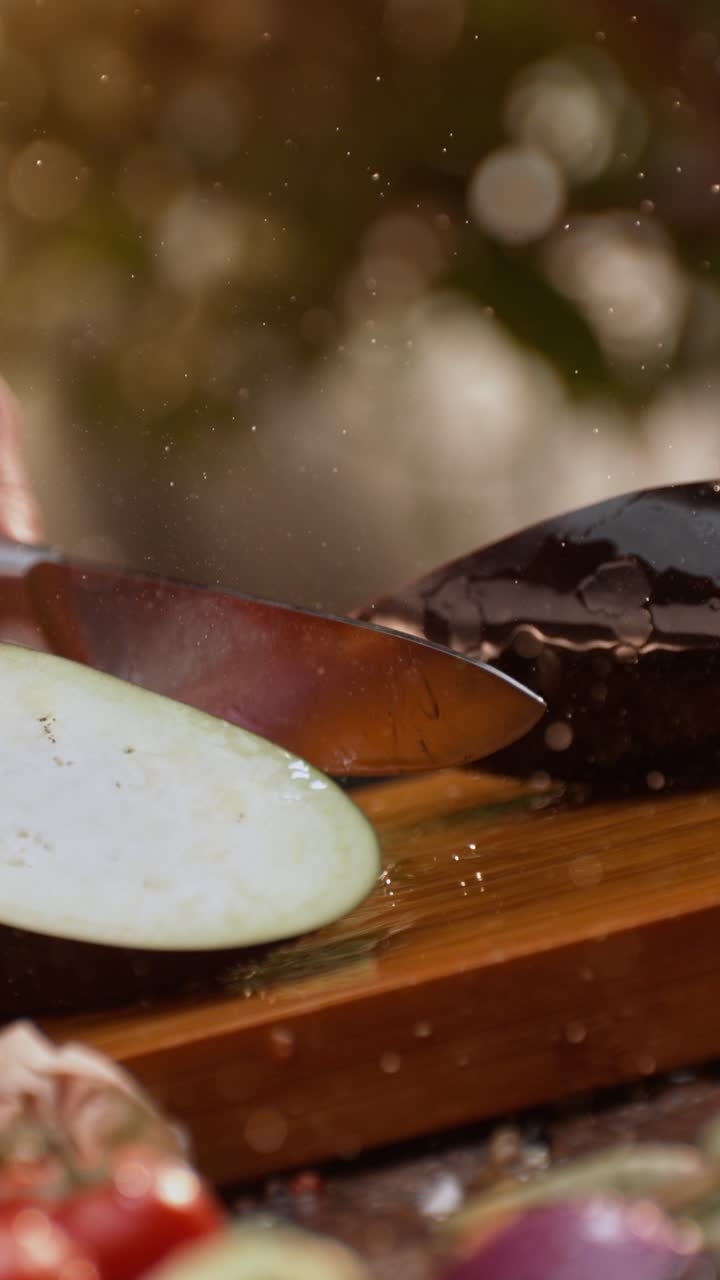 Slicing eggplant on a cutting board