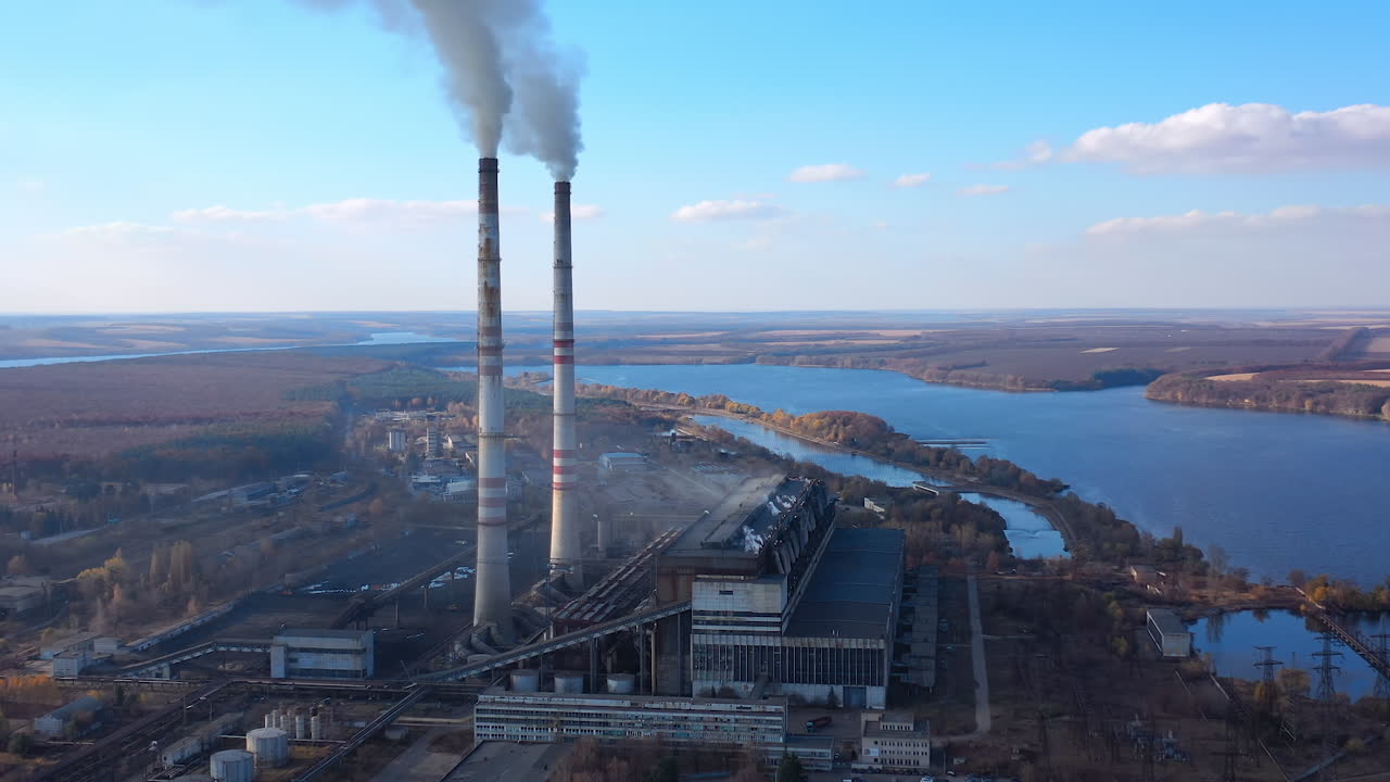 Atmospheric air pollution from industrial smoke. Pipes with chemical smoke from industrial plant. Thick smoke and steam pollute the environment. Climate change and global warming