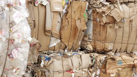 Bales-of-cardboard,-paper-stacked-at-recycling-plant