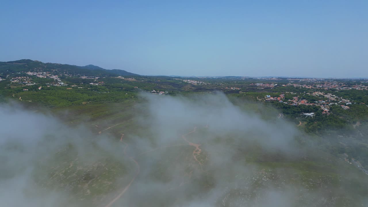 Aerial view from the fog that covers Cascias landscape with SIntra mountains at background,Portugal