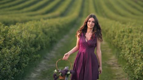 pretty woman in a dress spinning in a field with a basket of flowers