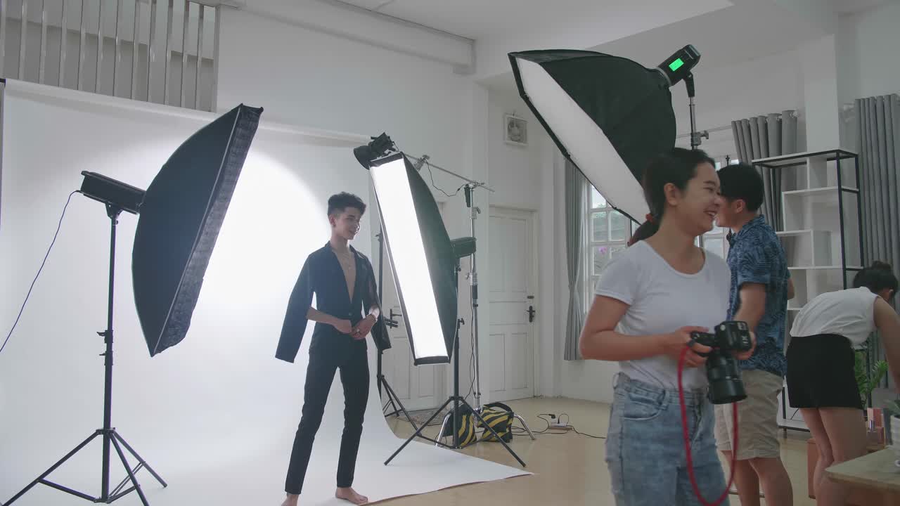 Behind The Scenes On Photo Shoot: Asian Model Poses For A Photographer, She Takes Photos With Professional Camera