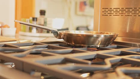 a side angle close up of a pan cooking on a stove