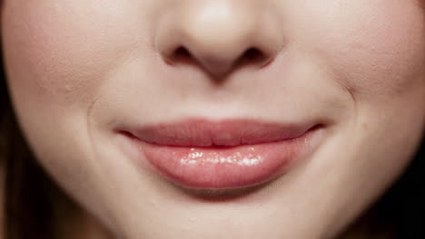 cute girl lips making smile in studio. beautiful woman mouth smiling in atelier