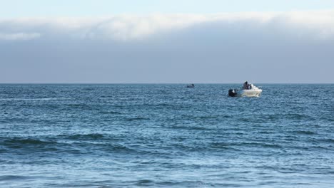 Wide-Shot-Of-man-Relaxing-On-A-Boat-Cruising-In-The-Middle-Of-The-Sea-with-some-waves-crashing,-Europe