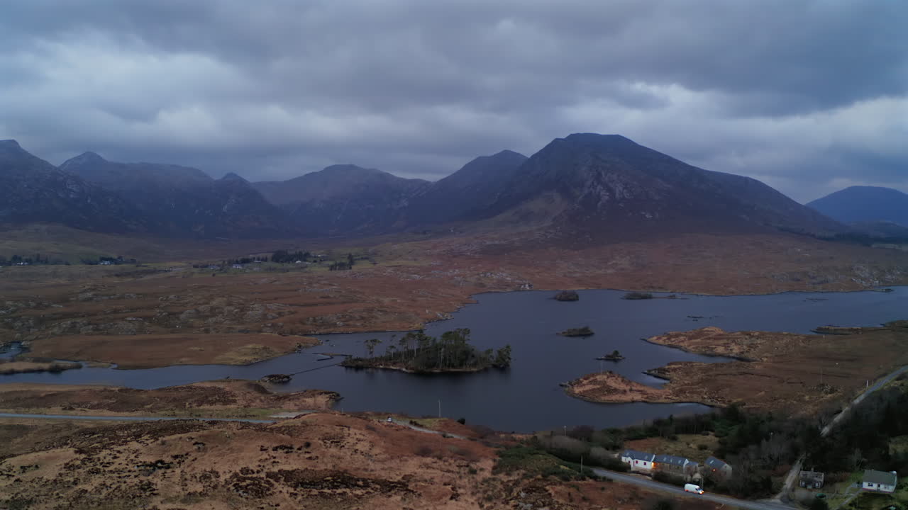 Aerial wide shot of Pine Island at twilight, framed by the Twelve Bens. Connemara