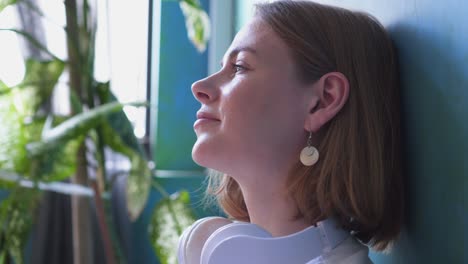 charming woman leaning on wall and listening favorite track