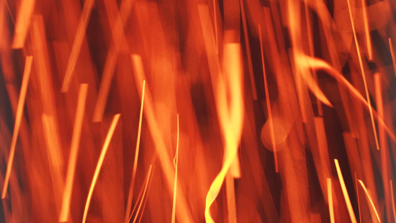 Burning red sparks of fire. Fast moving particles in a pipe at a factory