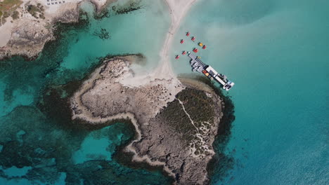 Birds-eye-of-Nissi-Beach's-crystal-clear-waters,-golden-sand-of-Ayia-Napa-Cyprus