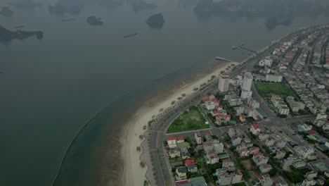 tilt down shot of city view from high above hạ long bay, vietnam with misty weather adding a mystical atmosphere