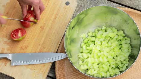 cutting up tomatoes for salad with sharp knife stock footage