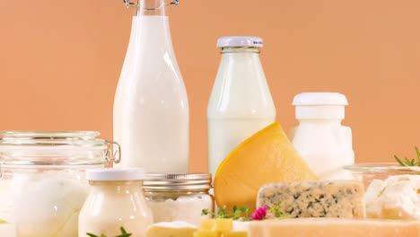 assorted dairy items displayed against orange backdrop