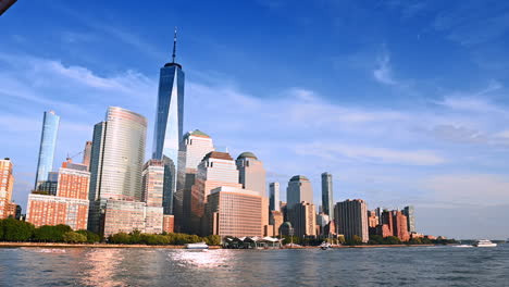bright sun lights the facades of the modern diverse high-rise buildings. low angle view at new york architecture from the riverscape
