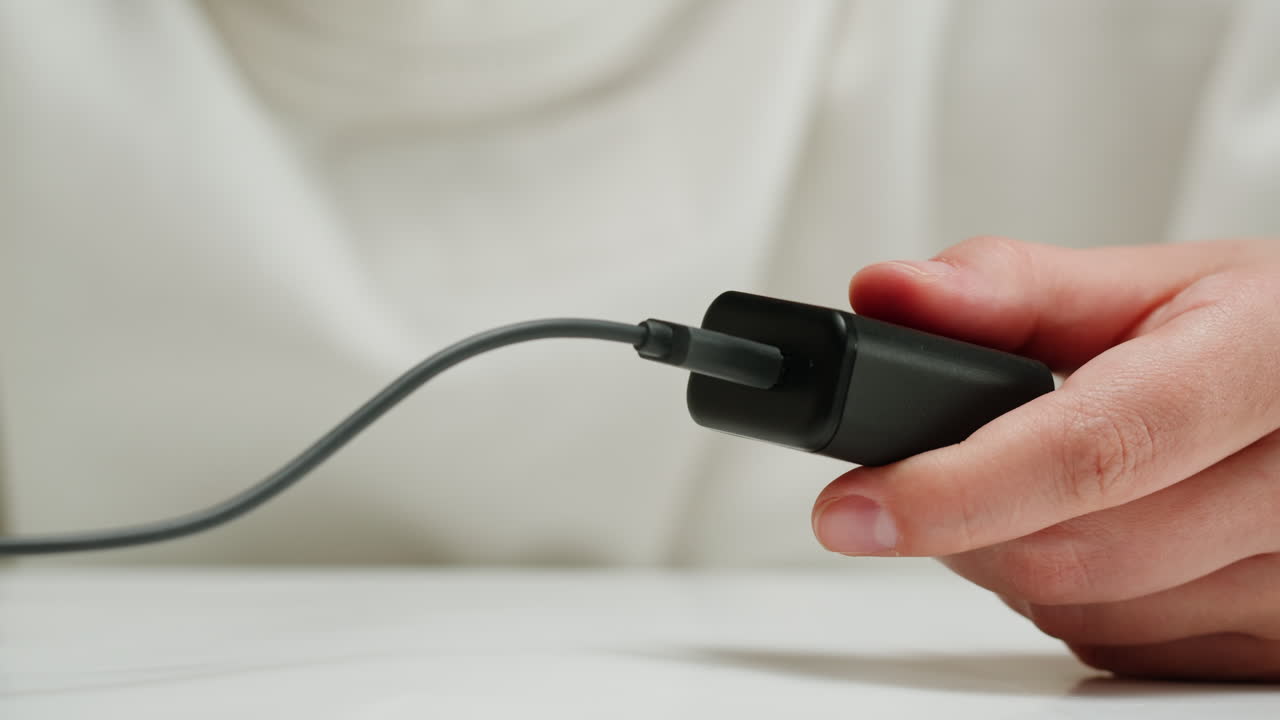 Connecting wire with usb charger close-up.Tangled wires on table. Chargers for electronic devices