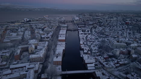 Aerial-View-Of-Nidelva-River-Between-Trondheim-City-Buildings-At-Winter-In-Norway