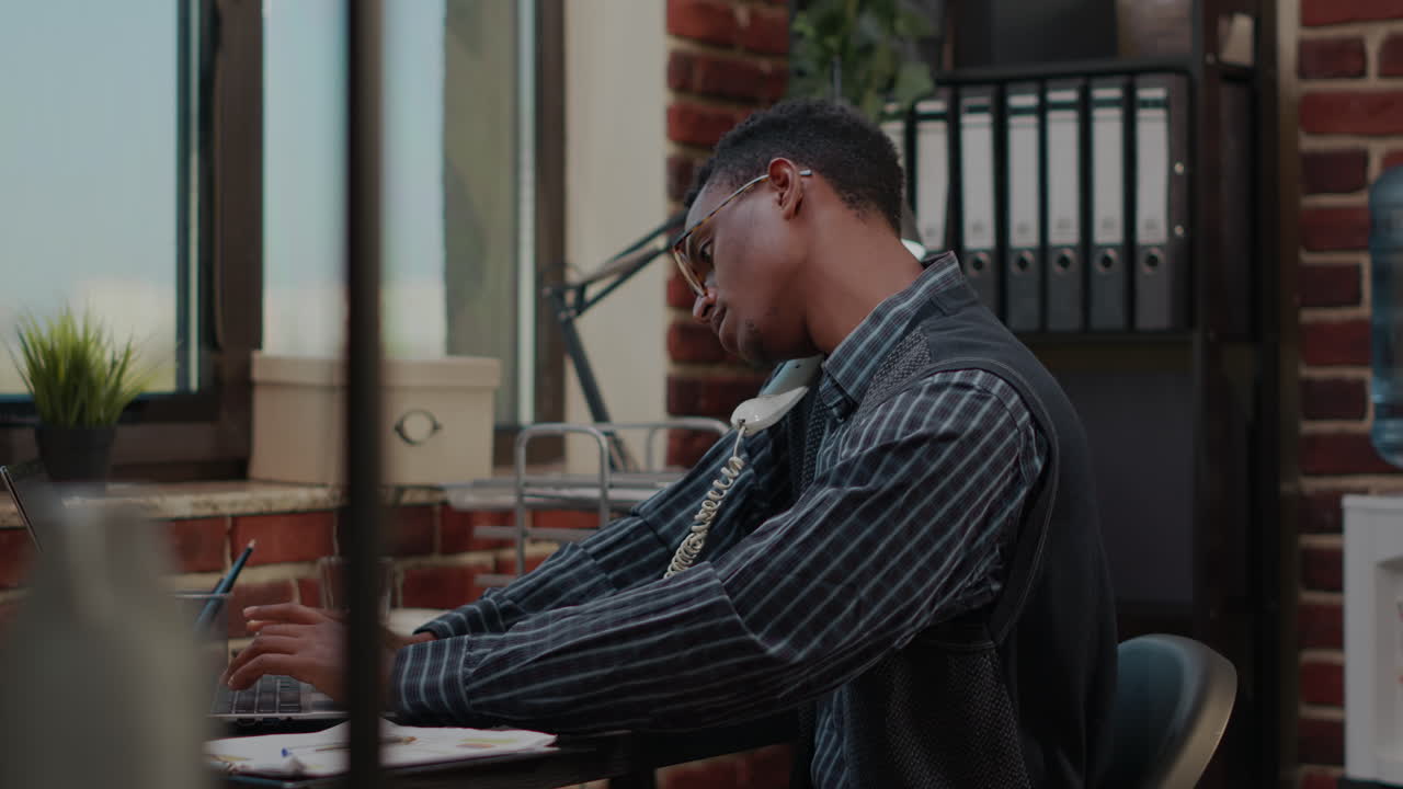 Business man answering important call on landline phone