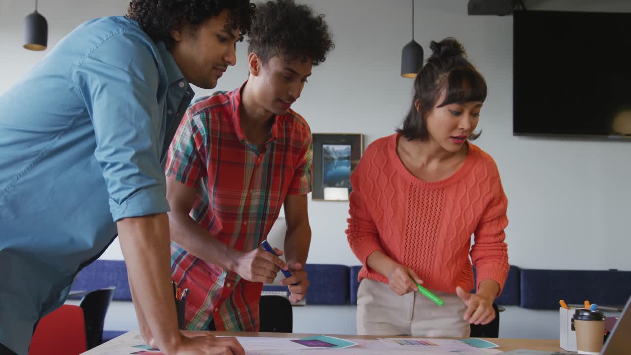 Happy diverse business people discussing work during meeting at office