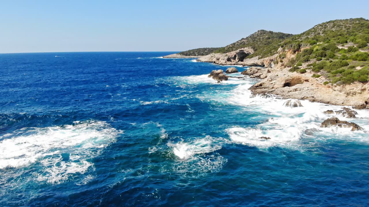 Oceano blu con onde spumeggianti che si infrangono sulle scogliere costiere - Spiaggia di Gerusalemme a Erisos, Grecia - ripresa aerea con drone