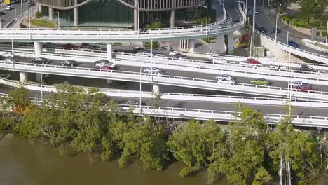 drone trucking pan follows cars driving on highway commuting in city