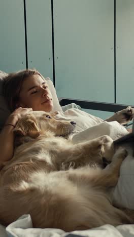 woman and dog sleeping in bed