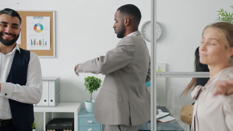 happy business team dancing in office