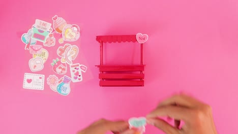 decorating miniature kissing booth for valentine's day with stickers
